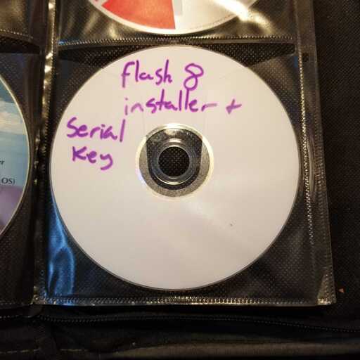 A CD with a handwritten label reading "Flash 8 installer + serial key"